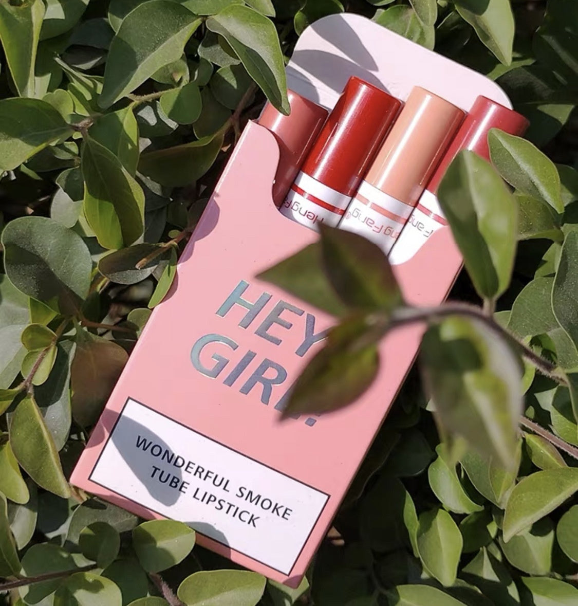 Long-Lasting Moisturizing Lipstick Set 4 Piece displayed among green leaves with vibrant shades for beautiful lips.